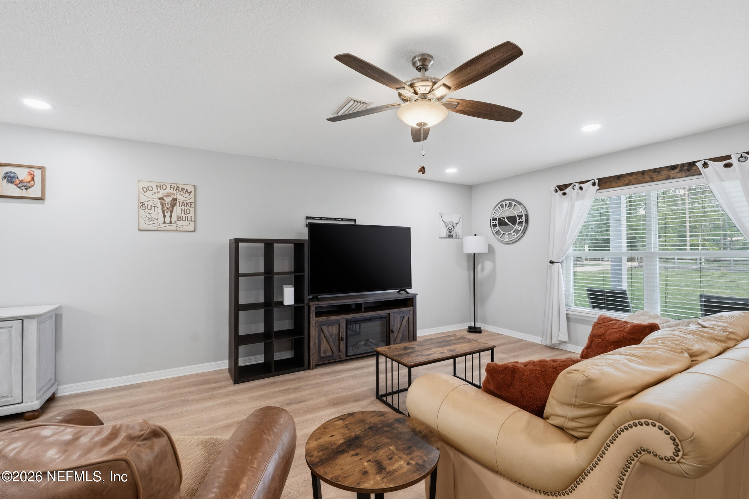 2471 Iris Street Middleburg, FL 32068 - Photo 18 of 40 a living room with furniture and a flat screen tv