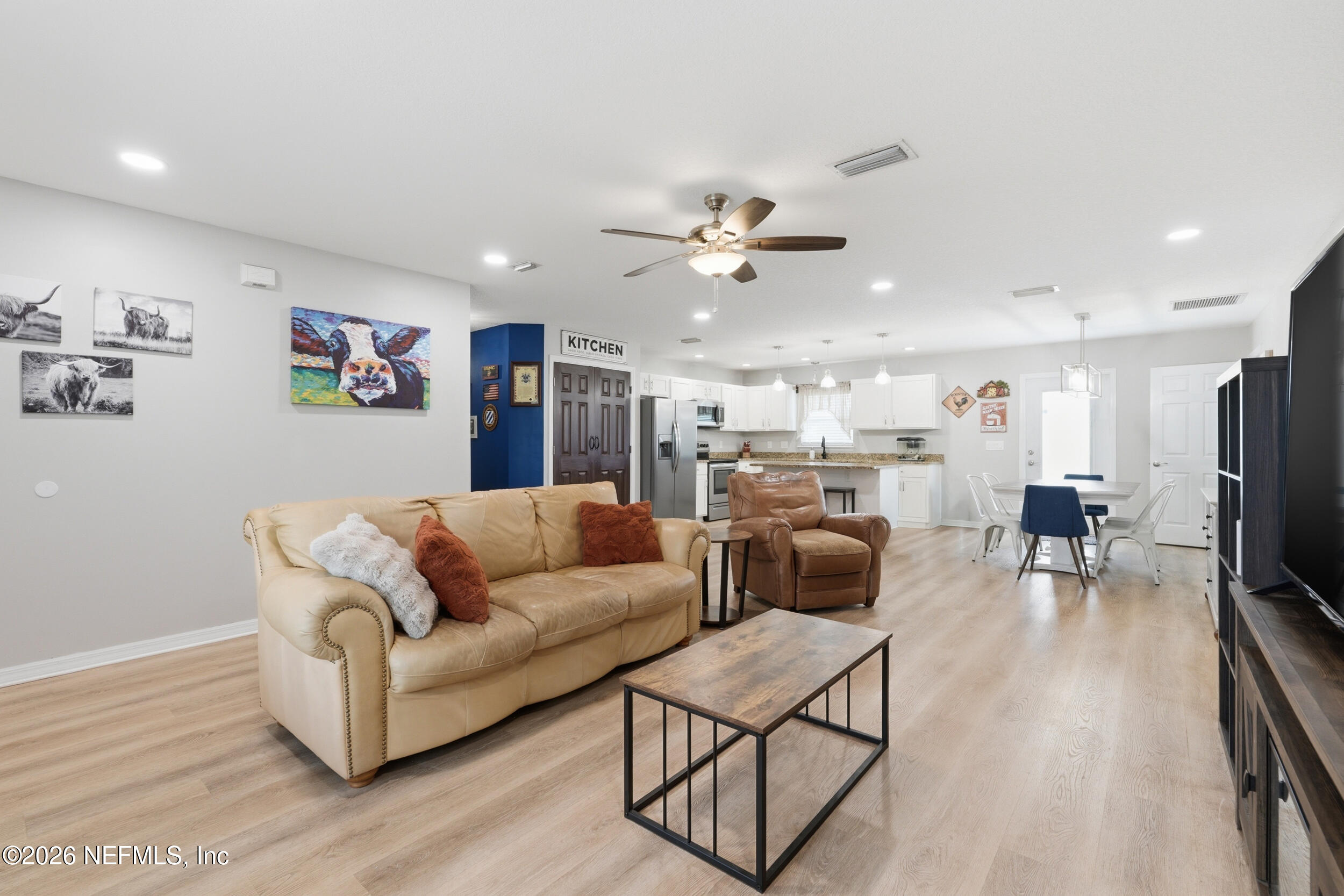 2471 Iris Street Middleburg, FL 32068 - Photo 19 of 40 a living room with furniture kitchen view and a chandelier