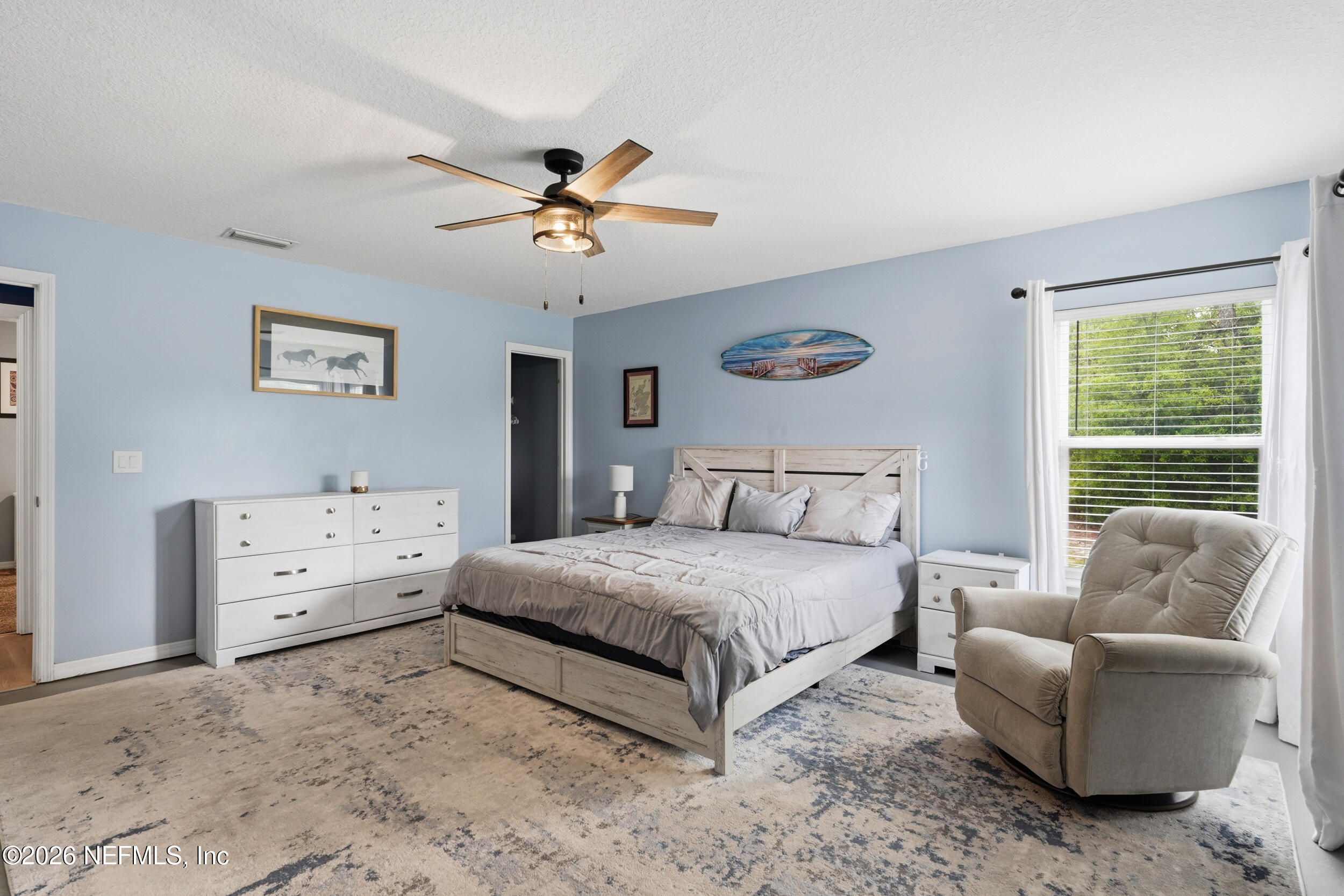 2471 Iris Street Middleburg, FL 32068 - Photo 21 of 40 a spacious bedroom with a bed and ceiling fan