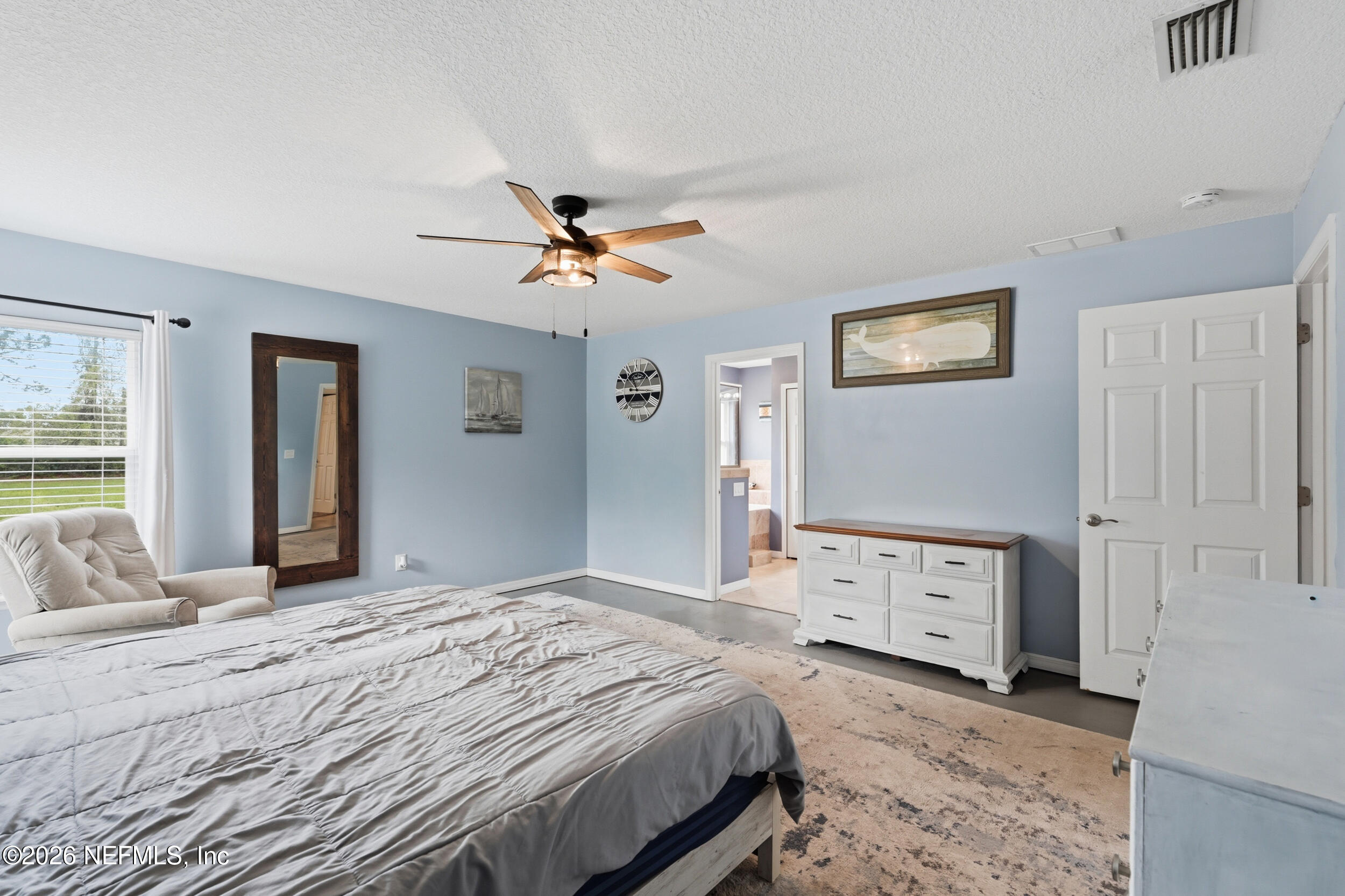 2471 Iris Street Middleburg, FL 32068 - Photo 22 of 40 a bedroom with a bed and a chandelier