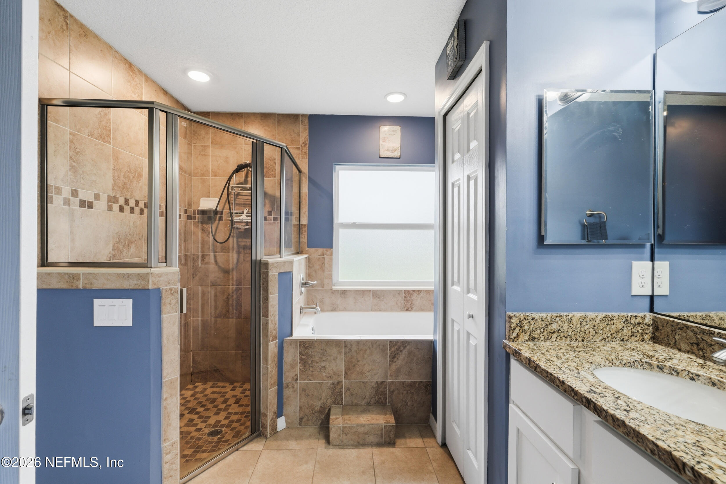 2471 Iris Street Middleburg, FL 32068 - Photo 25 of 40 a bathroom with a granite countertop shower a sink and a mirror