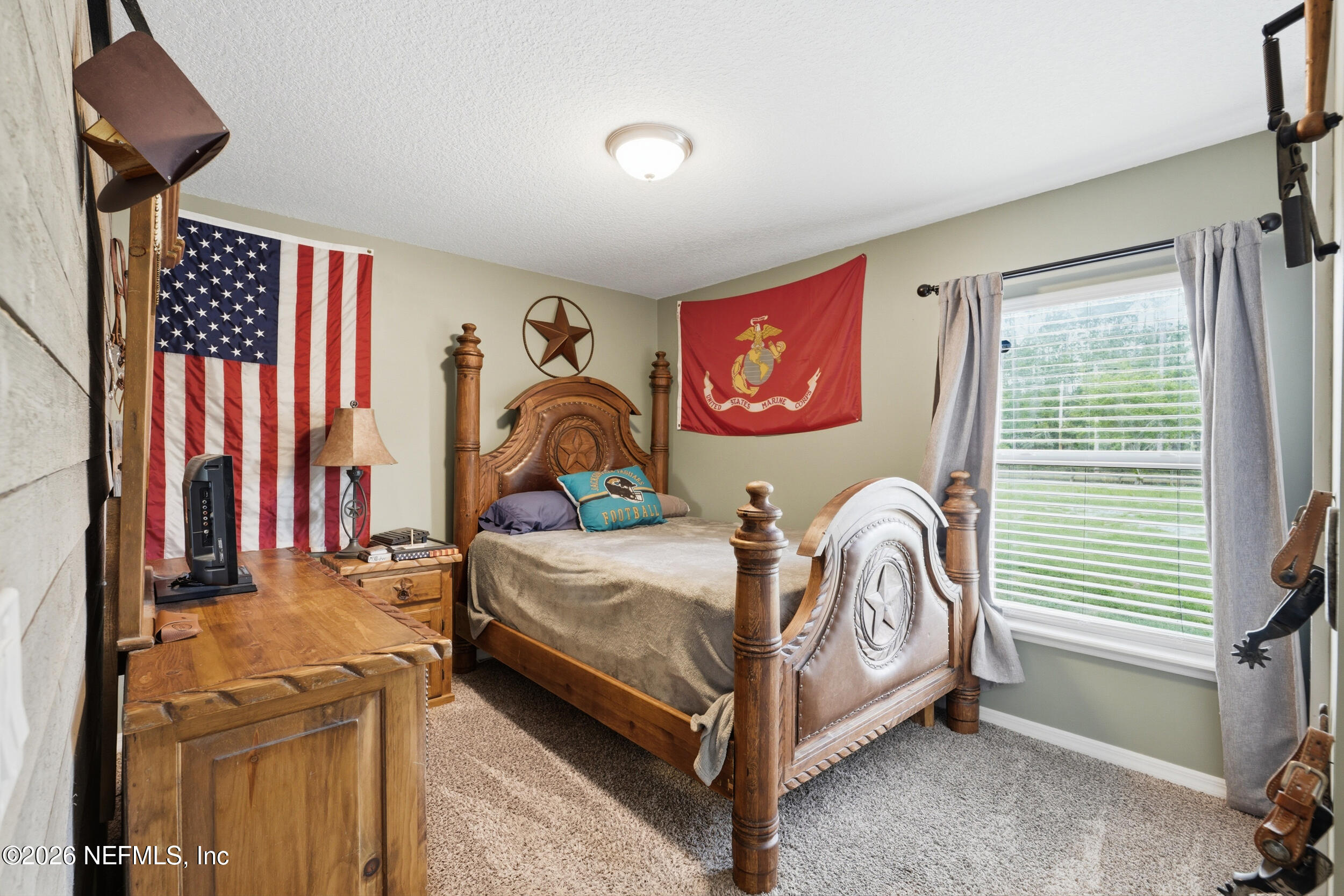 2471 Iris Street Middleburg, FL 32068 - Photo 27 of 40 a bedroom with a bed and a painting on the wall
