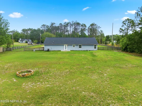 a view of a big yard with a house