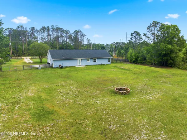 a view of a big yard with a house