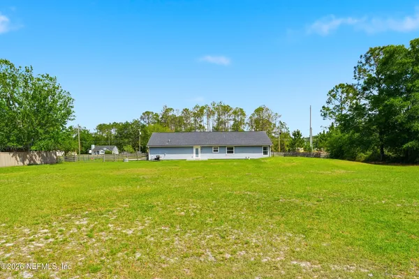 a view of a big yard with a large tree and a big yard