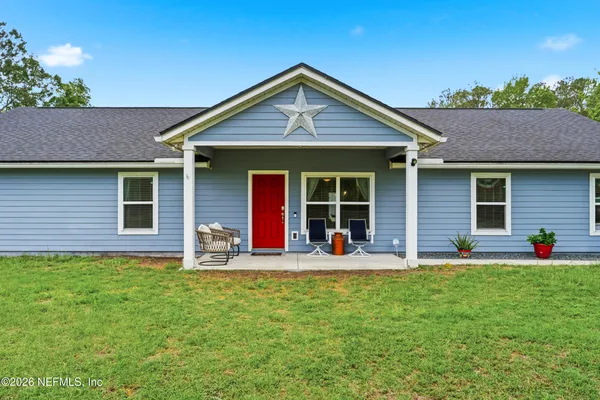 a front view of house with yard and porch