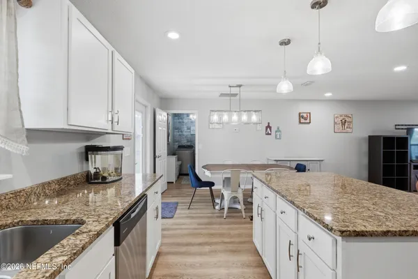 a kitchen with granite countertop a sink and stove
