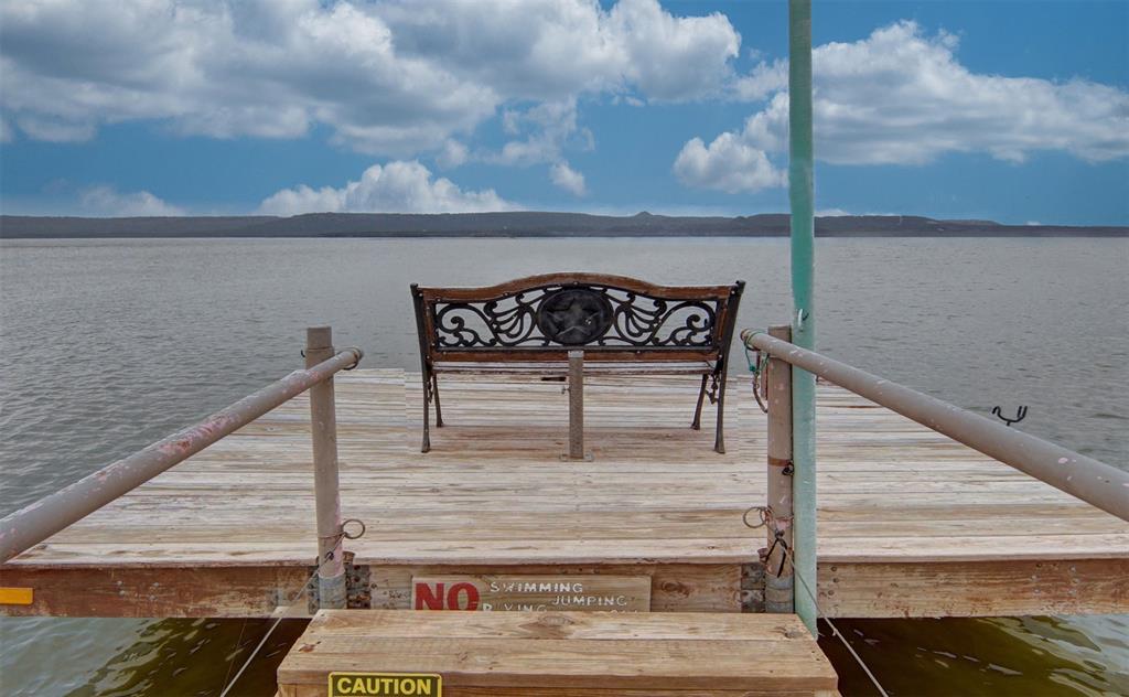 Dock area featuring a water view