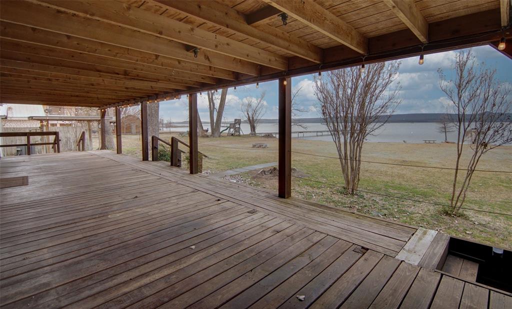 1059 Airport Road Graford, TX 76449 - Photo 30 of 37 Wooden deck with a water view and a lawn