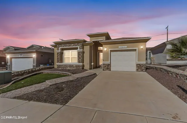 a bathroom with a granite countertop sink a mirror and a shower
