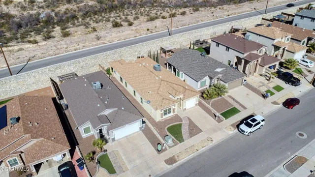 an aerial view of residential houses with outdoor space and parking