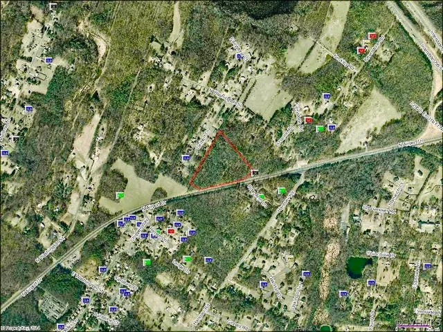 a backyard of a house with lots of green space and a fountain