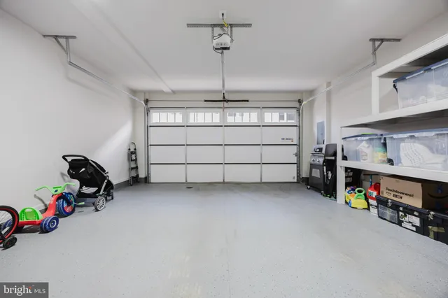 a kitchen with granite countertop white cabinets and stainless steel appliances