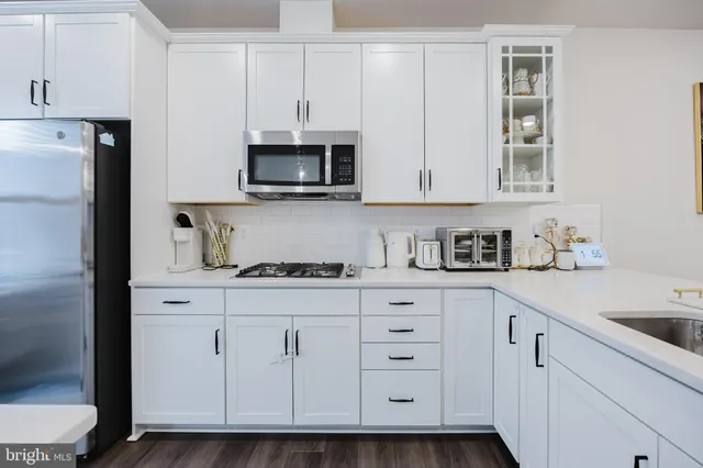 a large white kitchen with a large island