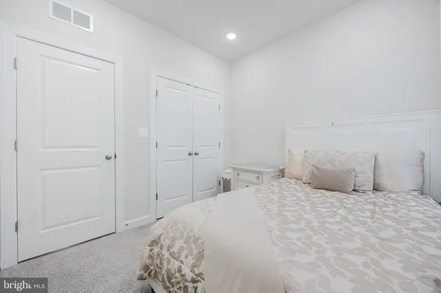 a backyard of a house with table and sofas