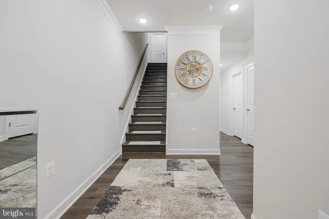 a view of a hallway with wooden floor and closet
