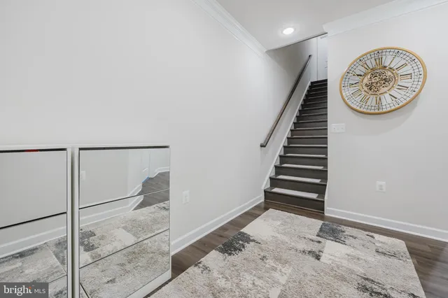 a view of a big room with windows and chandelier fan