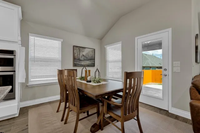 a view of a dining room with furniture and window