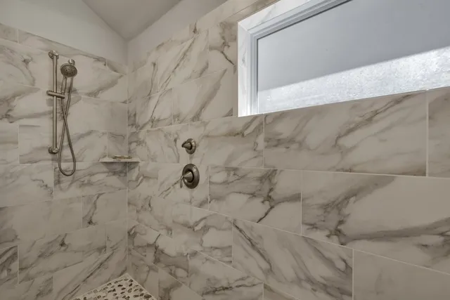 a bathroom with a bathtub and shower