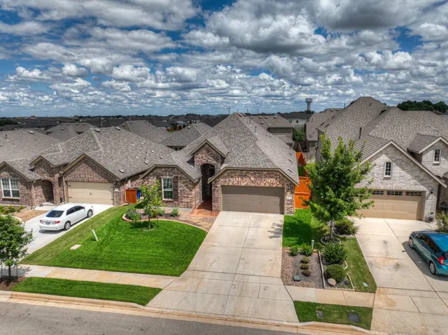 an aerial view of a house with a yard