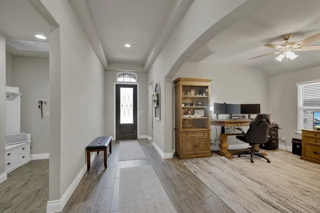 a view of a workspace with furniture and a bedroom