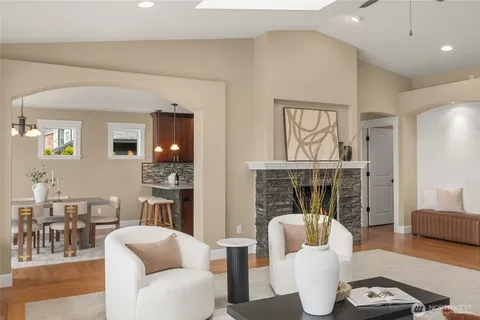 a living room with furniture a fireplace and a table