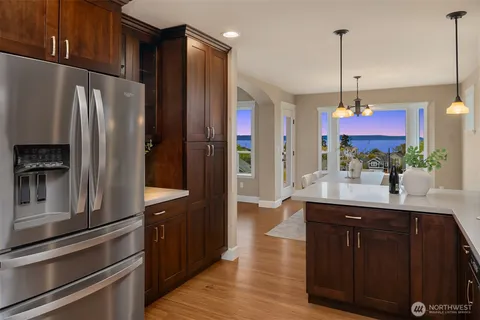 a kitchen with granite countertop a refrigerator and a sink