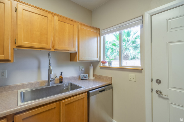 700 North Main Street, Unit F3 Washington, UT 84780 - Photo 11 of 34 Kitchen featuring light wood cabinetry, a stainless steel sink with a high-arch faucet, a window with exterior foliage, and a white paneled door