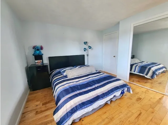 a bedroom with a bed and a potted plant