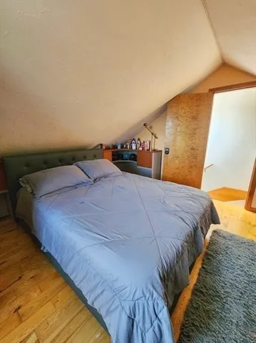 a bedroom with a bed and a potted plant