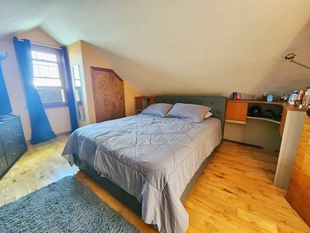 a bed sitting in a bedroom next to a window