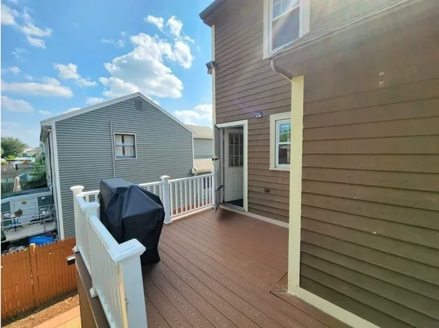 a view of a deck with wooden floor and a yard