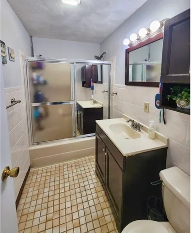 a bathroom with a sink a toilet and mirror