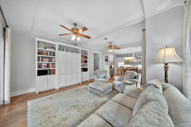 a living room with furniture and a chandelier