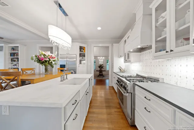 a large kitchen with stainless steel appliances granite countertop a lot of counter space and a sink