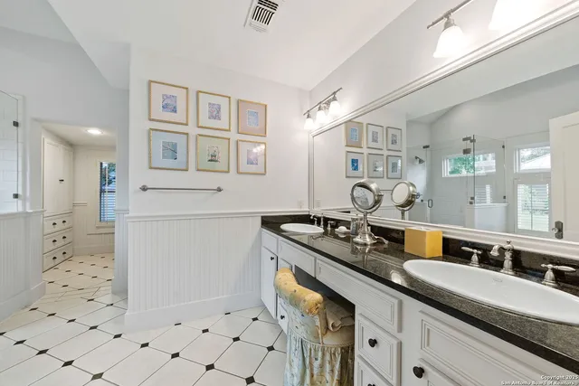 a bathroom with a sink double vanity and a shower