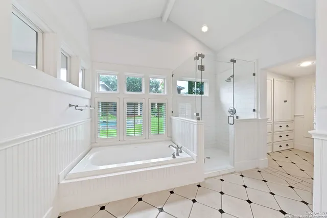 a bathroom with a bathtub and a shower