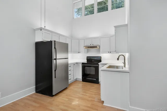 a kitchen with a refrigerator sink and stove