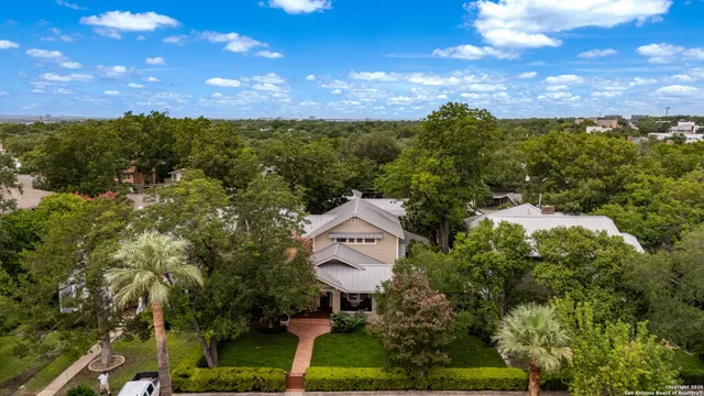 an aerial view of a house with a yard