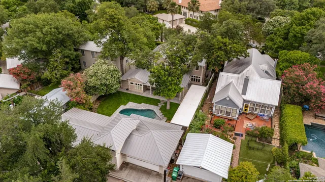 an aerial view of a house with swimming pool and garden