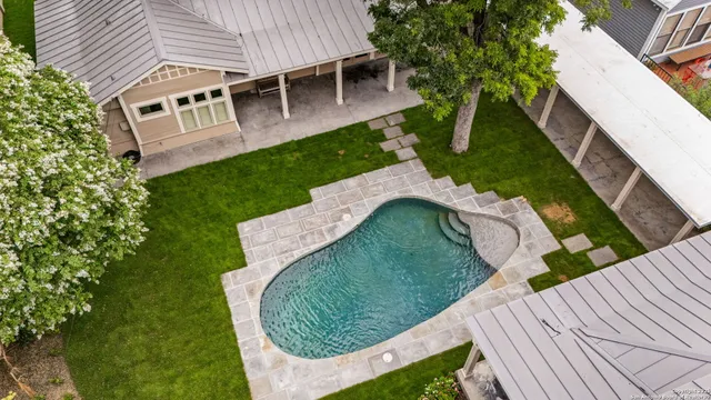 a view of a house with a backyard and sitting area