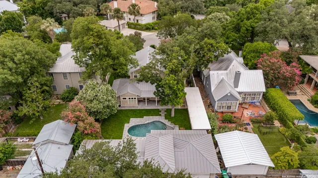 an aerial view of a house with a garden and trees
