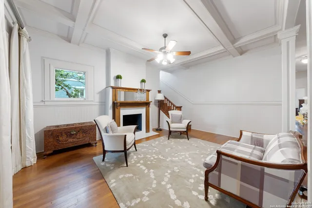 a living room with furniture a fireplace and a table