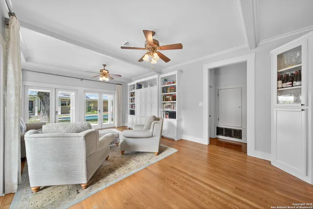 a living room with furniture and a ceiling fan