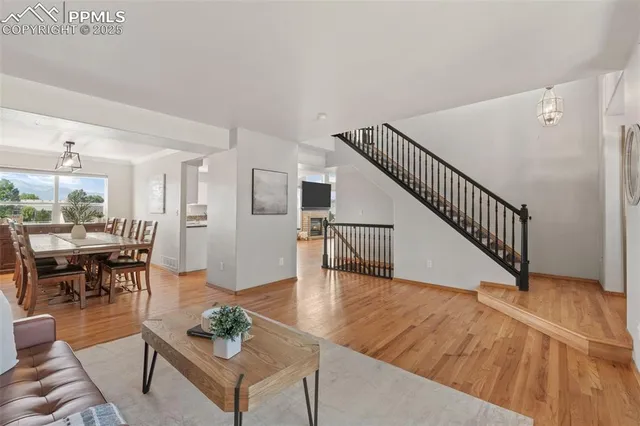 a view of entryway and hall with wooden floor
