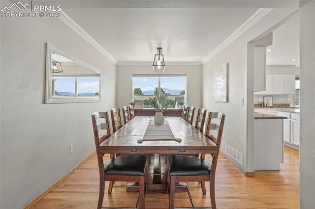 a view of a dining room with furniture window and wooden floor