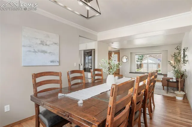 a view of a dining room with furniture and wooden floor