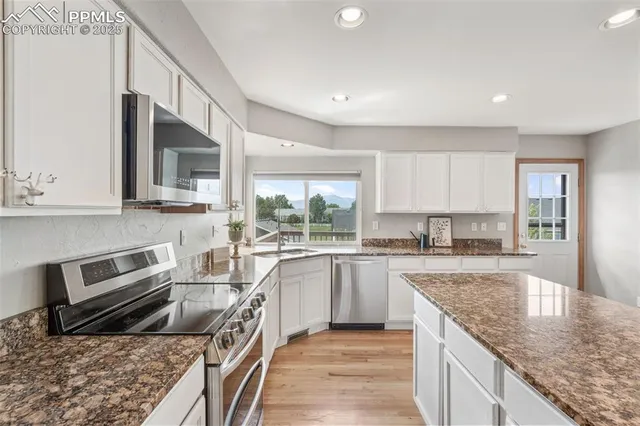 a kitchen with a stove sink and cabinets