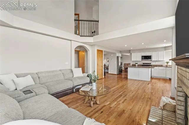 a living room with furniture and kitchen view