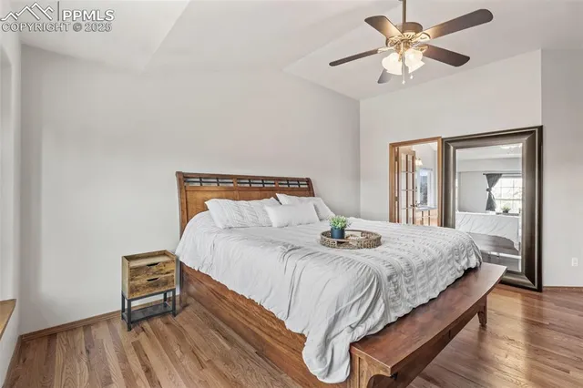 a bedroom with a bed and a chandelier